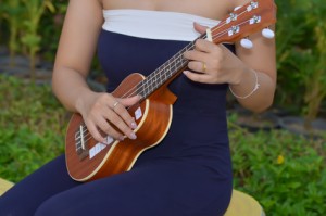 young woman plays ukulele thailand